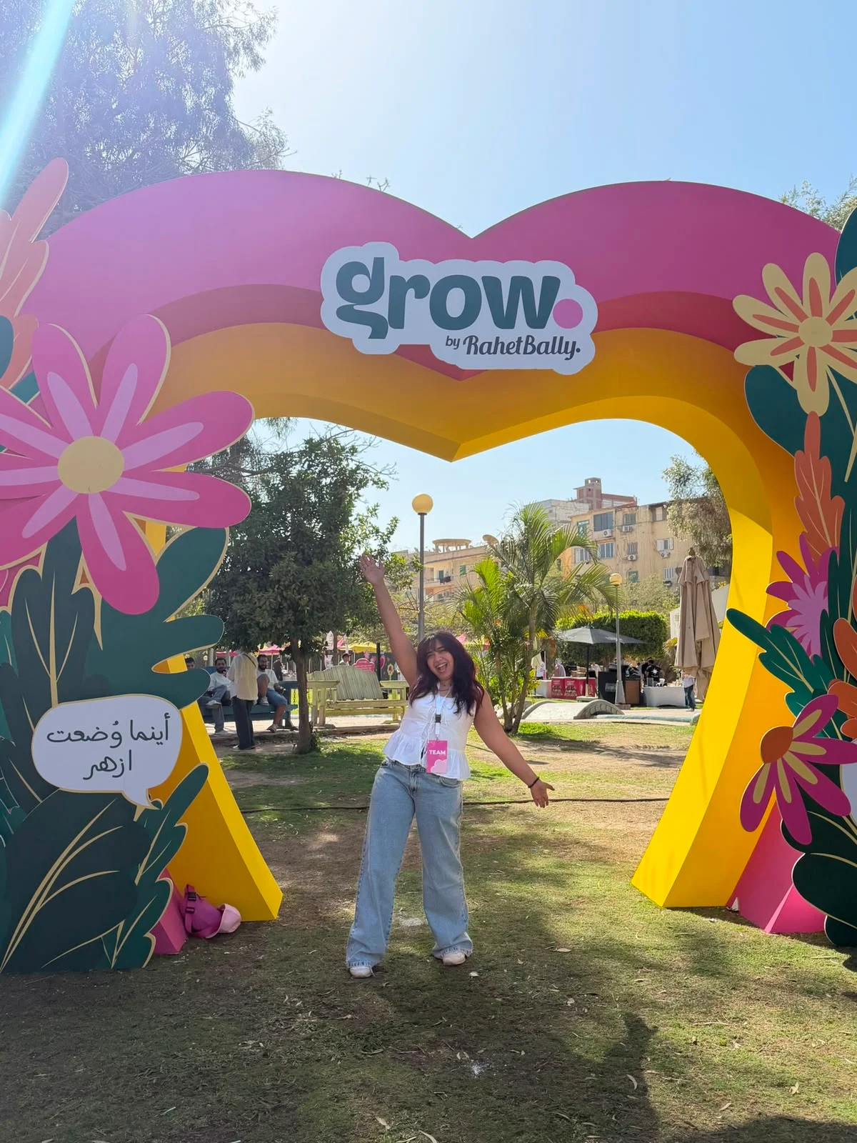Malak celebrating under the GROW event arch she designed